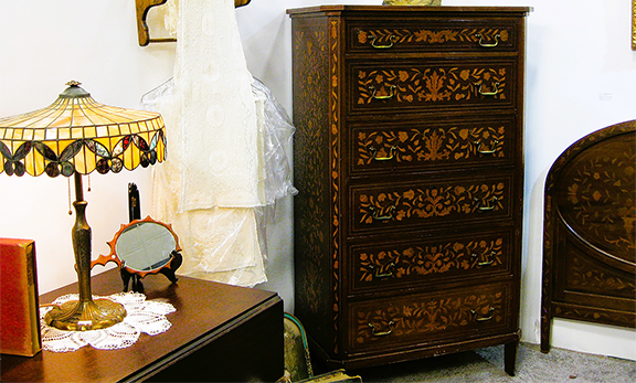 Debbie Lund of Wheeling, West Virginia, assembled an eclectic booth that included a Dutch marquetry tall chest and matching headboard, $3500, and a butterfly lamp, $475.