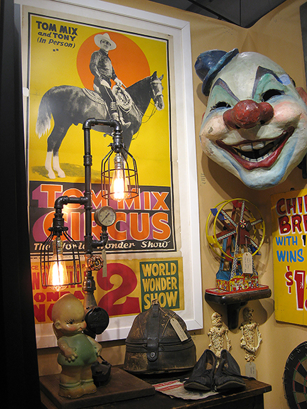 The Dixie Gypsy, Dickson, Tennessee, brought signs, historical photos of baseball teams, and some desirable flat storage cabinets. The large poster for an in-person appearance by Tom Mix and his horse Tony was $775, and the papier-mâché clown head was $665.