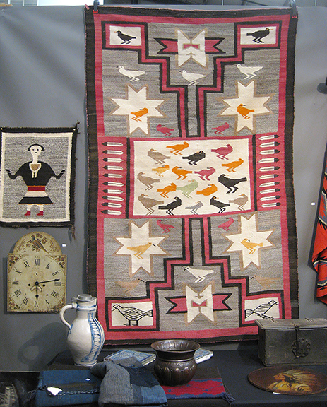 Longtime exhibitor Tom Delach of Columbus, Ohio, always brings an eye-catching display. His Storm pattern Navajo rug, 1925-30, with lines to the four corners representing lightning, makes wonderful use of birds facing in opposite directions. The one-of-a-kind rug was $3800.