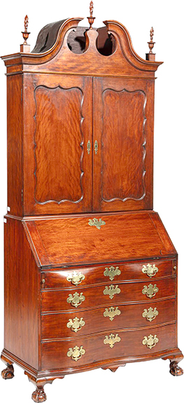 Boston Chippendale carved birch secretary bookcase, 1770-80, attributed to John Cogswell, inscribed on the back “December 27 1804,” with a broken-arch pediment, finials, shaped paneled doors, a slant-front lid with a fitted interior, a serpentine case with four graduated drawers, and ball-and-claw feet, 101