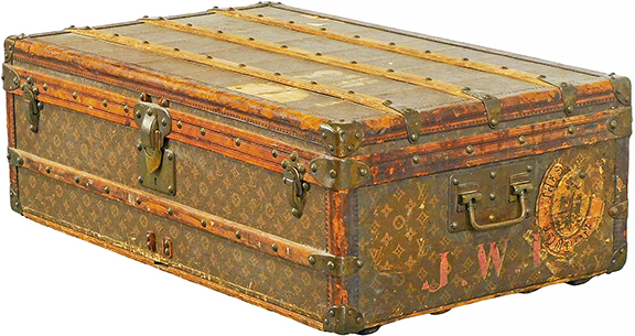 Louis Vuitton cabin trunk, early 20th century, serial no. 135688, monogram pattern exterior, red monogrammed initials “J.W.I.,” remnants of stickers including New York and London, brass hardware, white cloth-lined interior, missing interior tray, “Bond Street” label bottom right interior of lid, 12½