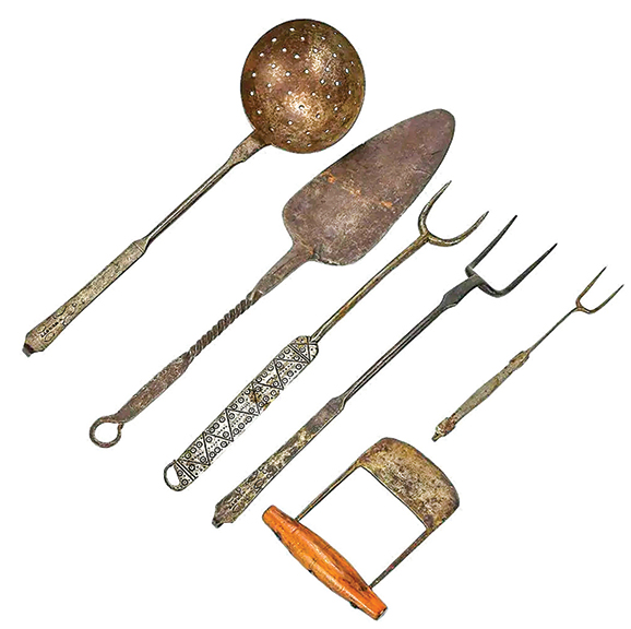This lot consisted of six articles of wrought-iron kitchenware from the late 18th and early 19th centuries. The perforated ladle and the largest of the forks are punch decorated and marked “W. Werntz” for a Lancaster, Pennsylvania, blacksmith. The spade-shape twist-handle spatula and the ladle are each 19½