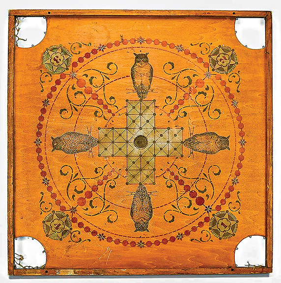 The double-sided wooden game board (one side shown) is from the Edward Mikkelsen company of Chicago. The board displays a patent date of 1901. It is marked “The Owl Game Board,” and it was advertised that it could be used for 75 different games, many of which appear to be carom-like “flick” games. The corner netting has deteriorated, but the board displays a nice overall alligatored surface. The 28½