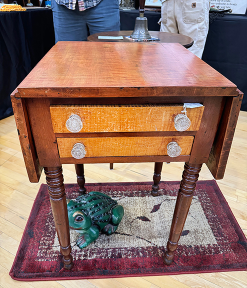 A cherry and tiger maple two-drawer drop-leaf stand was offered at $875 by Maureen Fenton of Topsham, Maine.