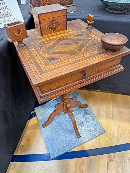 This one is a mystery. This inlaid one-drawer smoking table dates to the first half of the 20th century, and all the objects on the table are attached to it. What they were used for is unknown. The top appears to include an inlaid depiction of a burned match and cigar. Scott Smith of Biddeford, Maine, asked $750 for it. He had a jewelry box by the same hand.