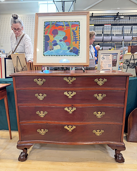 This Boston mahogany serpentine-front ball-and-claw foot chest, circa 1780, with graduated drawers and original brasses was $2100 from Martin Ferrick of Lincolnville, Maine. The contemporary painting on top is Fishing by Maine artist Mary Bourke. Ferrick asked $950 for the acrylic on paper. 
