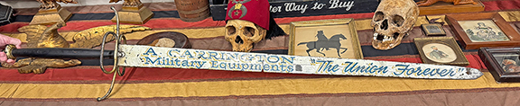 A trade sign in the form of a sword, marked &ldquo;A. Carrington Military Equipments, &lsquo;The Union Forever,&rsquo;&rdquo; was $1500 from Todd Dean of Oklahoma City, Oklahoma. The sign once belonged to Massachusetts dealer Rex Stark (1947-2023). It hung near the stove in his house.