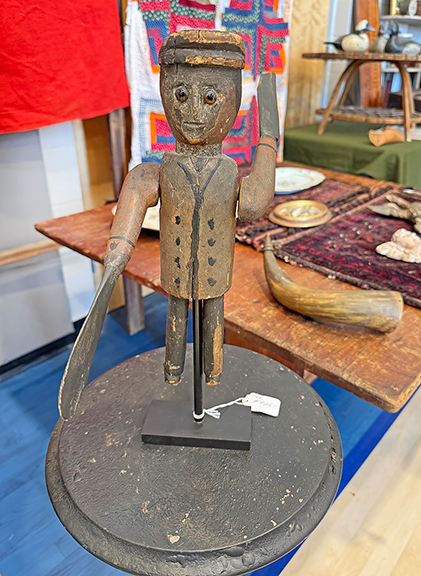 These two carved folky figures (left), probably from the 1950s, were once in the collection of Beverly Archer (b. 1948), a writer and actress who appeared on television&rsquo;s Mama&rsquo;s Family and Major Dad. The figures were tagged $525 from Christopher Stanley of Christopher Stanley Antiques, Bremen, Maine, who joked that it was appropriate that the figures were archers. Stanley also had an 1890s painted whirligig with glass eyes. From a collection in Harrington, Maine, it was priced at $825.