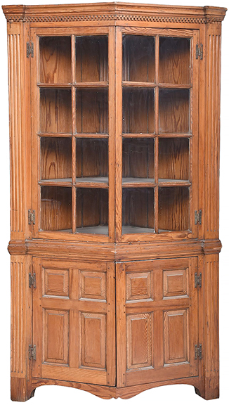 Southern yellow pine “turkey breast” corner cupboard, Delmarva Peninsula, probably Eastern Shore of Virginia, 18th century, single-case construction with a dentil-molded cornice over two glazed doors and two panel doors, with rosehead nails, brass H-hinges, fluted side panels, and fixed interior shelves. Measuring 83
