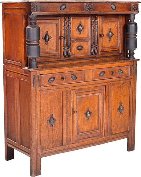 This two-part oak court (or short) cupboard may be the work of the John Taylor shop, Cambridge, Massachusetts, circa 1680. On the left, middle, and right of the top tier are the stylized initials “I M B.” There are two paneled doors in the upper section and two drawers over a central paneled door. Only the Internet chased the 57¾