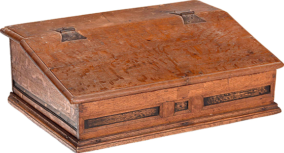 An absentee bidder claimed this circa 1690 paneled oak and part ebonized slant-lid tabletop desk from Essex County, Massachusetts, for $7380 (est. $5000/7000). The hinges are wrought-iron butterflies. The interior of the 8½