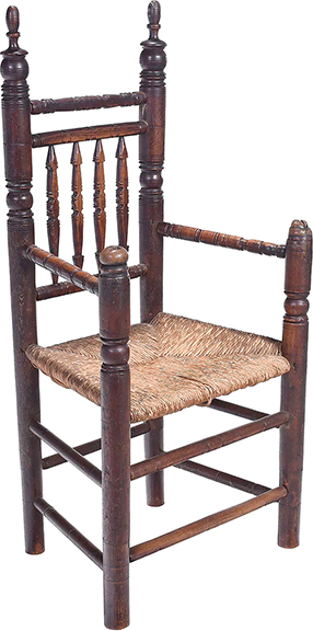 Here is a circa 1690 coastal Massachusetts great chair in ash with a spindle back, rush seat, and “great old surface.” The 49