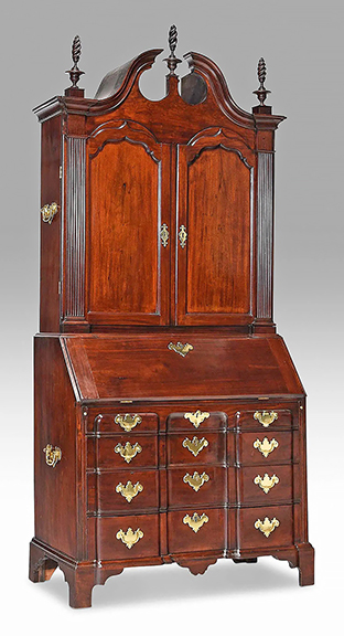 The Boston Chippendale block front mahogany desk and bookcase attributed to Benjamin Frothingham (1734-1809) of Charlestown, Massachusetts, has sturdy handles on the upper and lower cases. The 1760-70 desk/bookcase once sat in the living room of collector and preservationist Ralph Carpenter Jr. (1909-2009). Photos appear in volume VII of American Antiques from the Israel Sack Collection. The 96¼