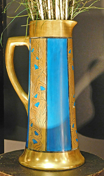 Here’s a tall 1920s or 1930s Arts and Crafts “peacock feather” pitcher from David Weidner of Dark Flowers Antiques, Haverhill, Massachusetts. Priced at $395, it was probably made in France, then shipped here for decoration, Weidner explained, adding that the design came from Keramic Studio magazine of Syracuse, New York.