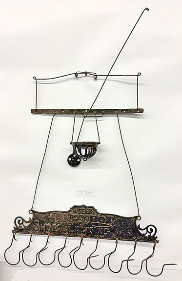 The country store sack holder, marked “Use Handy Box French Show Blacking,” was $895 from Mr. and Mrs. Smith Antiques, Harlan, Iowa.