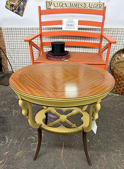 The circa 1930 table with mahogany veneer marquetry, a brass rail, and swan’s head decoration was $325 from Lanny Lumbert of Double LL Antiques & Collectibles, Portland, Maine. The German collapsible silk top hat with box, early 20th century, was $175; the bench in salmon-colored paint was $250; and the sign “Maj. Gen. James D. Alger,” who was known as “Gentleman Jim” when he was at West Point (Class of 1935), was $60. Alger attended Gould Academy in Bethel, Maine. The bench sold.