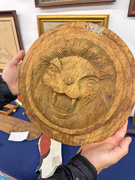 The double-sided carved wildcat or lion panel, 1930s, possibly from a door, was $250 from Evan Grant of Bremen, Maine.