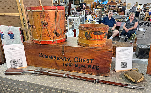 At left, an American militia drum, circa 1840, with an eagle, “North America,” and “Rush,” was probably the militia company’s town. The omission of an olive branch suggests an early Mexican War date, according to dealers Todd and Richard Dean of Edmond, Oklahoma. It was $1500. The 1842 Springfield musket was $3500. The commissary chest from the 13th New Hampshire Regiment was $300; the smooth-side canteen, captured from the Confederates in the Civil War, and reissued, still with its CSA stencil on the front, was $550. The toy drum was $450.
