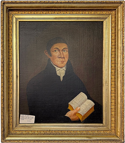 The 1780-1820 oil on canvas portrait of a man holding a Bible open to John 14 was $2495 from Rick Fuller of South Royalton, Vermont.