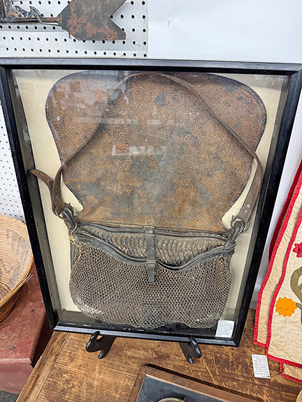 This framed early leather and netting game bag, 11