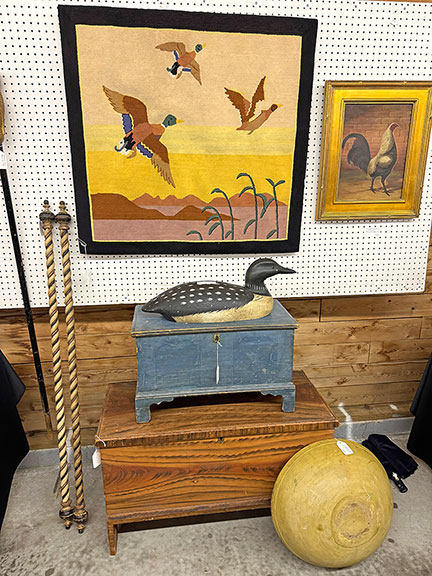 This colorful Grenfell weaving of ducks in flight was tagged $950 by Nancy and Craig Cheney of Mansfield, Ohio. The carved and painted loon, signed “JB,” was $495; the small blue painted blanket chest was $2100; the larger blanket chest with original paint decoration was $950; and the 19