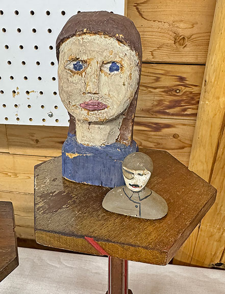 The large carved head came from the Vermont area, dating to the 1950s-60s, and was $135 from Thais Glazman of Child of Folk, New York City. The World War I-era carving—he was missing one half of his goggles—was $65.