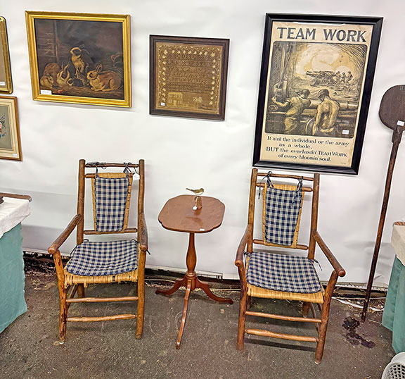 Michael and Lucinda Seward of Pittsford, Vermont, offered a pair of Adirondack armchairs for $225; a bird carving by Sandwich, Massachusetts, woodcarver Philip “Peter” Peltz (1915-2001) was $345; the early 19th-century cherry stand was $375, the 19th-century oil on canvas of bunnies, circa 1870, was $975; the 1830 needlework by Maria Bacon was $950; and the rare World War I “Team Work” poster by Burleigh Litho. Co., Troy, New York, was $950.