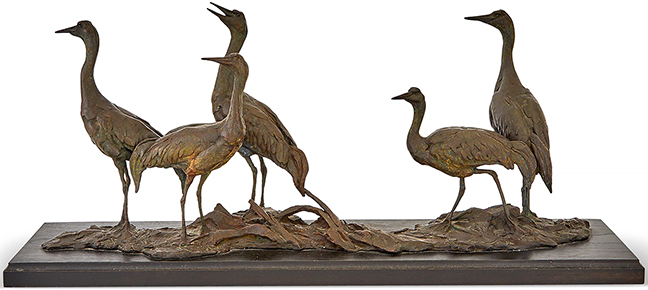 Patinated cast-bronze group of five wading birds cast from a model by Walter Matia (b. 1953), the base signed “Matia 4/36,” mounted to an ebonized oak base, 9¼