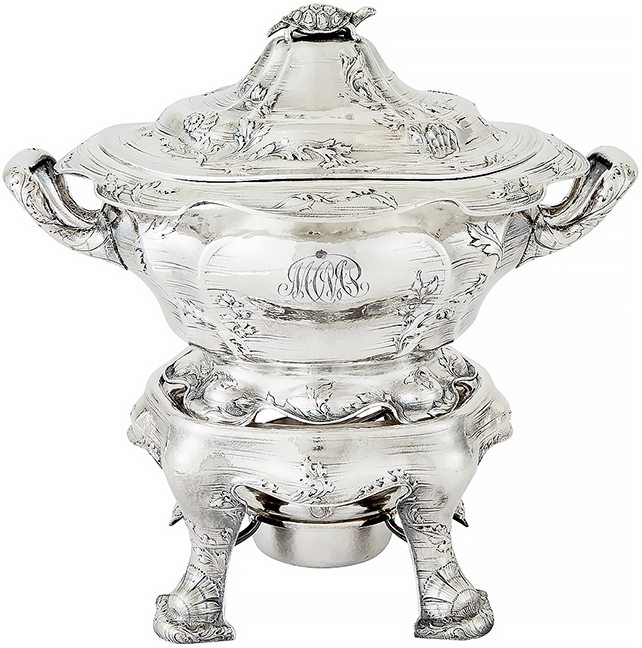 Soup tureen on stand, 1912, the bombé-form body and domed cover chased with scrolling seaweed and engraved horizontal bands to replicate water, the finial with a turtle, all raised on a stand with stylized shell-and-seaweed feet, 14