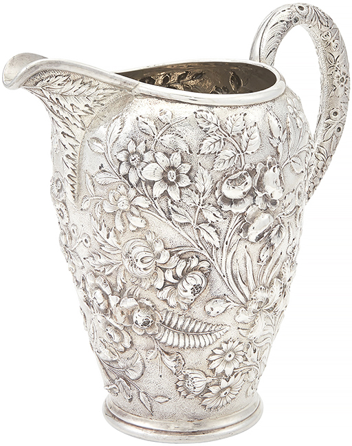 S. Kirk & Son Co. sterling silver water pitcher, early 20th century, the ovoid body chased overall with flowers and foliage, with an upswept loop handle, 9