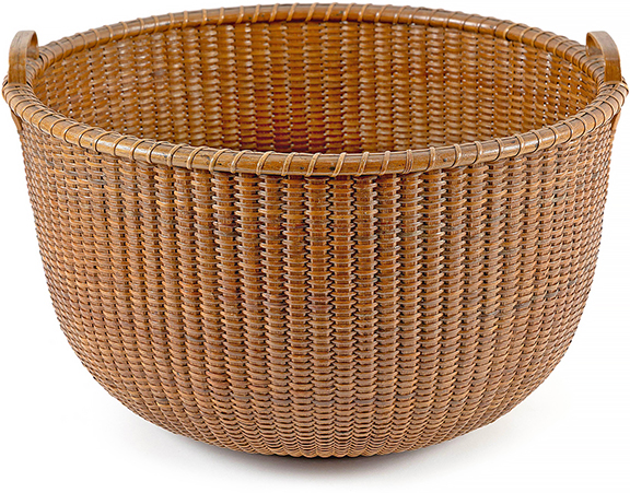 This rare bushel-size late 19th-century Nantucket Lightship basket is attributed to Captain Davis Hall, and measures 11½