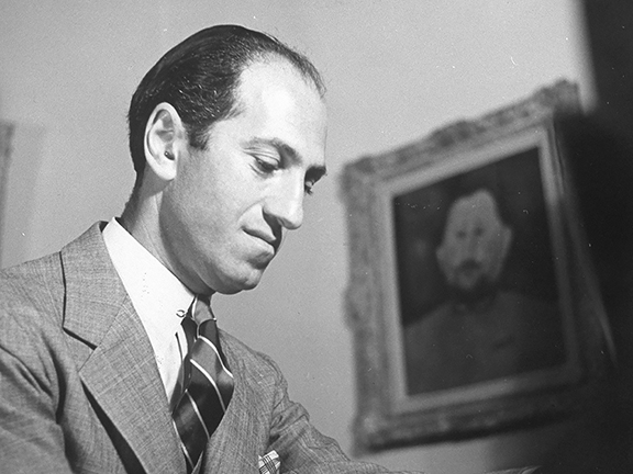 George Gershwin at 1019 Roxbury Drive, Beverly Hills, California, March 1937, with Amedeo Modigliani’s Portrait of Doctor Devaraigne. Photo courtesy Rex Hardy. Gershwin Collection, Library of Congress, Washington, D.C.