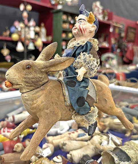 This German candy container in the form of a clown on a rabbit, 7½