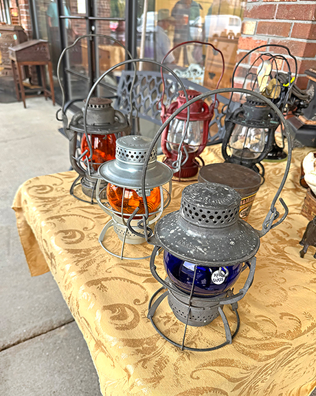 Bryan Provost of Marlborough, New Hampshire, offered railroad lanterns. From the rear: a Canadian Pacific example with an amber globe, priced at $200; New York, New Haven and Hartford with amber globe was priced at $250; and New York Central System with cobalt was priced at $250. Provost said they were never used—they were new old stock from the 1920s and 1930s. Provost also offered a Coleman 1951 Model 200A, so-called the Christmas lantern, for $750.