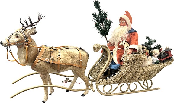 When Betty Bell is in the house, fantastic holiday antiques can’t be too far away. This German clockwork reindeer with a loofah sleigh, Santa, and period toys, 13