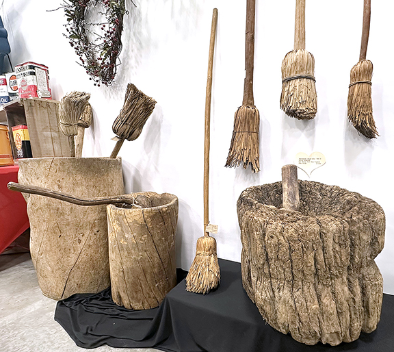 Mary de Buhr of Downers Grove, Illinois, is known for her wooden primitives. From left are a hornbeam and masher (partially obscured), sold during the show; a tall, heavy shaved broom, 1800-20, 52