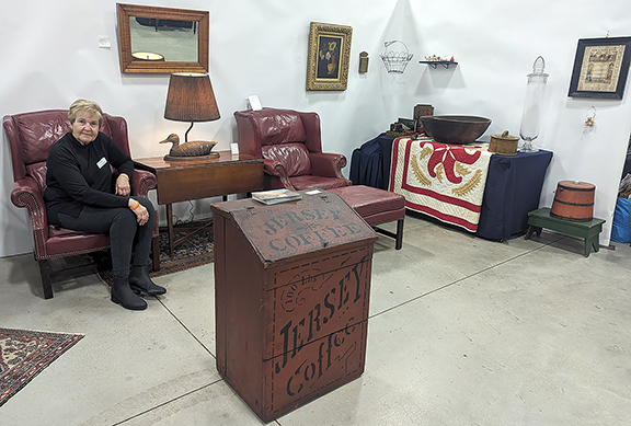 Jackie Spiegel of Lyons, New York, will do antiques shows from time to time, but her main interest now is her estate sales services organization. Spiegel is seen sitting in one of two vintage (circa 1970) leather Stickley wingback chairs, one with an ottoman, priced at $1050 for all. The group was to be in an upcoming estate sale Spiegel was doing, but first they made a showing at Hudson. Also in Spiegel’s booth was an early cherry drop-leaf table (between the chairs) with a stretcher base, priced at $345. The Ken Harris lamp on the table with a magnum decoy was $175. The 19th-century 26
