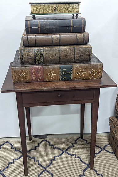 These storage boxes crafted to look like books enjoyed a great deal of attention in the dealer space of Stephen-Douglas Antiques. The large box on the bottom was priced at $1100. The others ranged in price from $200 to $750.