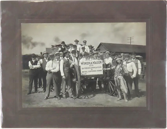 Here is photographic evidence of the strength of the Winona Wagon Company’s wagons and their outer bearing axles and metal-covered hubs. The Winona, Minnesota, firm was a preeminent midwestern wagon maker in the late 19th and early 20th century. As part of its marketing plan the company staged various opportunities to celebrate the strength of its wagons, sometimes loading them with people, stones, or concrete pillars. The young lady dressed in the costume of a Dakota Native American princess may have been a play on the similarly named “princess” in the popular turn-of-the-20th-century book Wenonah’s Stories for Children by Clara Louise Burnham and Warren Proctor. This 7