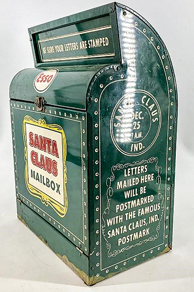 This 1950s Santa Claus Mailbox from Esso is designed to be hung on the wall, likely at an Esso service center. Each side panel is printed with a message stating that letters to Santa deposited in the box would be forwarded so that they would receive the Santa Claus, Indiana, postmark. The 17