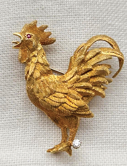 This 18k gold rooster has something to crow about. Its eye is a ruby, and the spur of one leg is a diamond. The 1¾