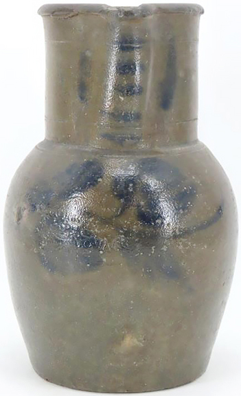 This James River stoneware pitcher displays a faint impressed stamp indicating its maker as John P. Schermerhorn of Richmond, Virginia. The pitcher is decorated with a brushed cobalt floral design on the front and other brushed accents to the neck and spout. With a capacity of approximately one gallon and standing 11½