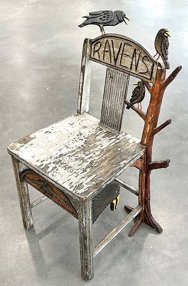 “Ravens” chair with three birds on the back and a tree, the back carved “R. Mueller” and titled “Roostin’ Ravens,” $375 from Karen Jack of Waddy, Kentucky. Jack said the chair came from the estate of Howard “Tom” Clark, an expert on Kentucky folk art. Carvings include a bird in flight on the seat rail and raven heads on both sides. The chair is 33