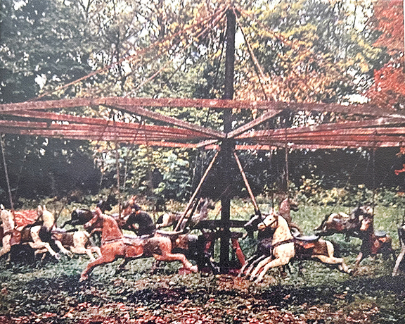 Two figures from a flying-horse carousel having 16 horses and two chariots, being sold as a complete unit for $26,000 by Seth Bixel of Bluffton, Ohio. The amusement ride was made by the United States Merry-Go-Round Company of Cincinnati, Ohio. The photograph shows the carousel, which was fully operational when last disassembled.