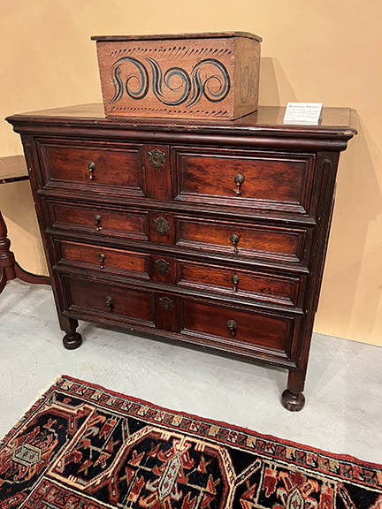 The circa 1695 oak and pine chest painted black and red, from Boston, was $14,000 from Norman Gronning Antiques, Shaftsbury, Vermont. The 18th-century Continental paint-decorated box has replaced hinges and was $950.