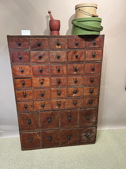 Paint-decorated 38-drawer apothecary cupboard with numbered drawers, $11,500 from Lisa S. McAllister of Clear Spring, Maryland. The mortar and pestle on top was $895, and the two boxes with handles were $750 (top) and $850.