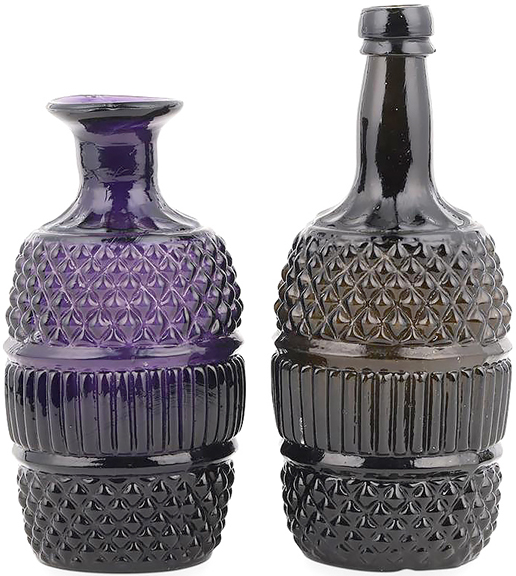 Amethyst and green three-mold blown decanters, circa 1830, American, each having a quilted pattern with a central ribbed section, one with a pontil scar to the base, 6¾