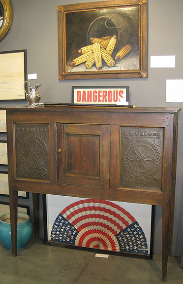 Michael Hall of Nashville, Tennessee, backed his display with a South Carolina hunt board safe in heart pine, circa 1850, with an extensive provenance, priced at $18,500. Below the hunt board safe, the flag fan was $950.