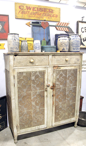 Good pie safes weren’t hard to find. Butch Lever of Hebron, Kentucky, had this bulky but intriguing example in cherry with old green-gray paint and punched designs consisting of alternating bold fylfots and hearts. Having cockbeaded drawers and turned legs, it stands 64½