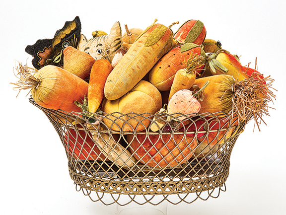 Impressive and lifelike, this collection of 54 luscious velvet fruits and vegetables, along with a velvet butterfly, a velvet two-faced moon, and a velvet cat with glass eyes, had been gathered over 40 years. The wire basket and its contents date to sometime between 1850 and 1900. Estimated at $18,000/25,000, the group sold for $37,500. Garthoeffner collection.